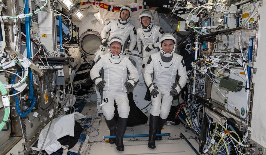 This photo provided by NASA shows clockwise from bottom left are, NASA astronaut Mike Fincke, Roscosmos cosmonaut Oleg Platonov, NASA astronaut Zena Cardman, and JAXA (Japan Aerospace Exploration Agency) astronaut Kimiya Yui gathering for a crew portrait wearing their Dragon pressure suits during a suit verification check inside the International Space Station’s Kibo laboratory module, Wednesday, Jan. 14, 2026. (NASA via AP)