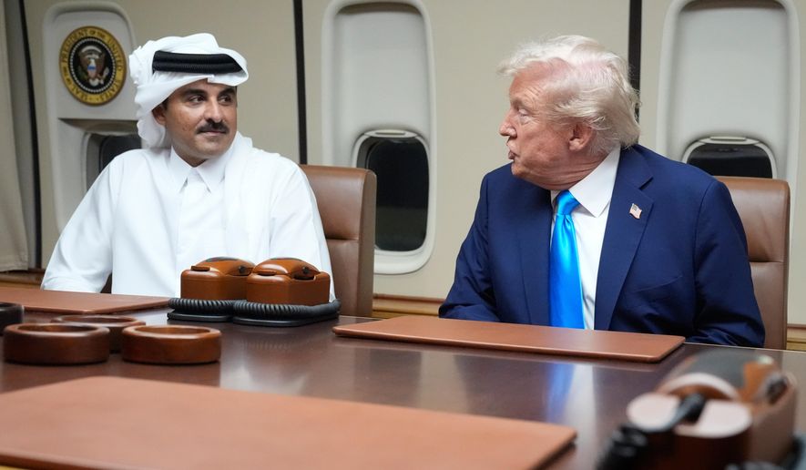 President Donald Trump, right, meets with Emir of Qatar Sheikh Tamim bin Hamad al-Thani aboard Air Force One at Al Udeid Air Base in Doha, Qatar, Saturday, Oct. 25, 2025. (AP Photo/Mark Schiefelbein, File)