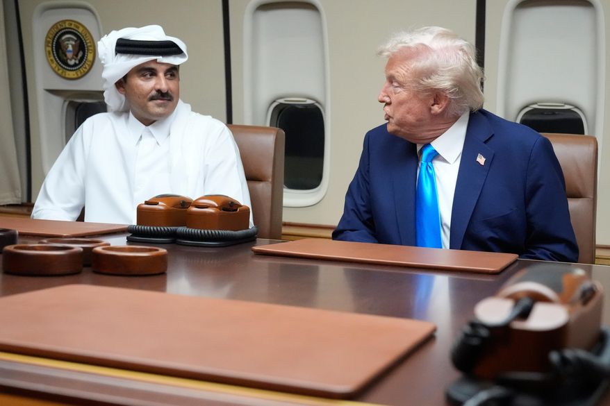President Donald Trump, right, meets with Emir of Qatar Sheikh Tamim bin Hamad al-Thani aboard Air Force One at Al Udeid Air Base in Doha, Qatar, Saturday, Oct. 25, 2025. (AP Photo/Mark Schiefelbein, File)