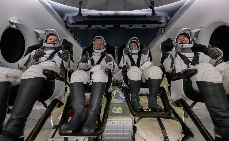 Roscosmos cosmonaut Oleg Platonov, left, NASA astronauts Mike Fincke, Zena Cardman, and JAXA (Japan Aerospace Exploration Agency) astronaut Kimiya Yui are seen inside the SpaceX Dragon Endeavour spacecraft onboard the SpaceX recovery ship SHANNON shortly after having landed in the Pacific Ocean off the coast of Long Beach, Calif., Thursday, Jan. 15, 2026. (NASA via AP)