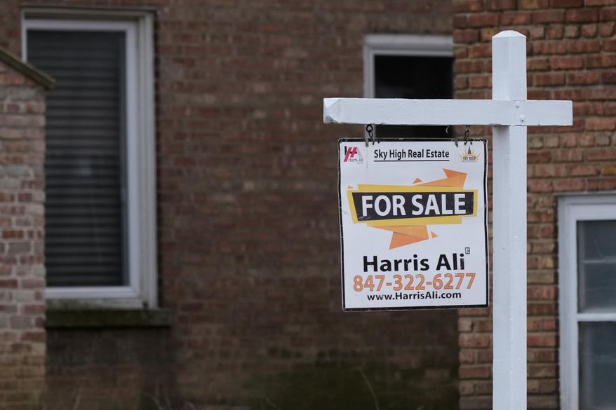 A "For Sale" sign is displayed in front of a home in Morton Grove, Ill., Tuesday, Jan. 6, 2026. (AP Photo/Nam Y. Huh)