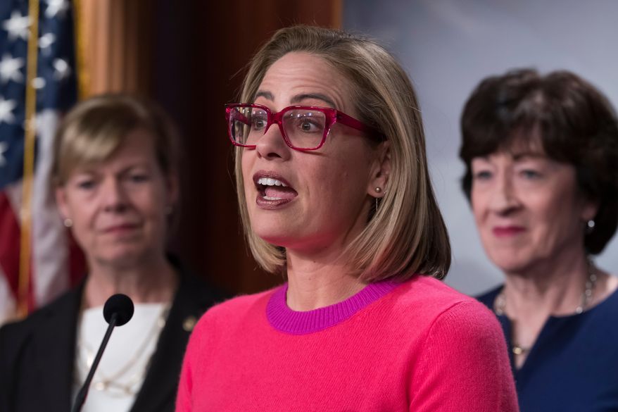 Former Sen. Kyrsten Sinema, flanked by Sen. Tammy Baldwin, D-Wis., left, and Sen. Susan Collins, R-Maine, speaks to reporters following Senate passage of the Respect for Marriage Act, at the Capitol in Washington, Nov. 29, 2022. (AP Photo/J. Scott Applewhite, File)