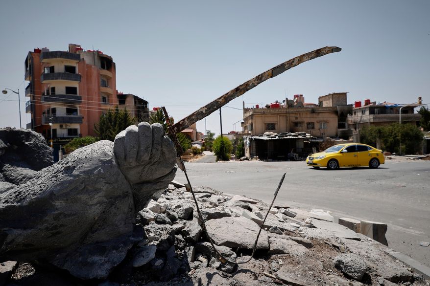 FILE - A car drives by a destroyed statue in the Druze-majority town of Sweida, Syria, July 25, 2025. (AP Photo/Omar Sanadiki, File)