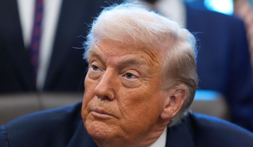 President Donald Trump listens to a question from a reporter after signing a bill that returns whole milk to school cafeterias across the country, in the Oval Office of the White House, Wednesday, Jan. 14, 2026, in Washington. (AP Photo/Alex Brandon)