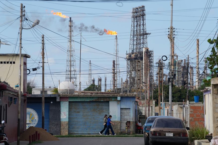 Flames rise from flare stacks at the Amuay refinery in Los Taques, Venezuela, Wednesday, Jan. 14, 2026. (AP Photo/Matias Delacroix)
