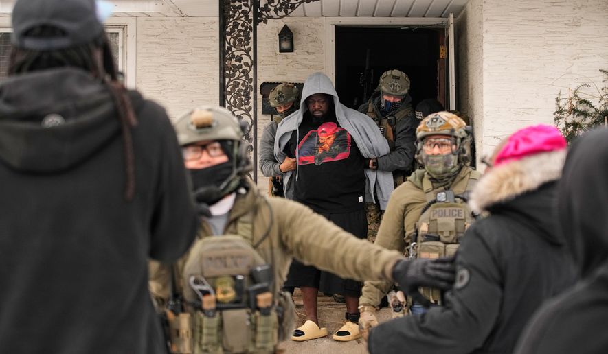 ADDS IDENTIFICATION: Garrison Gibson is arrested by federal immigration officers Sunday, Jan. 11, 2026, in Minneapolis. (AP Photo/John Locher)