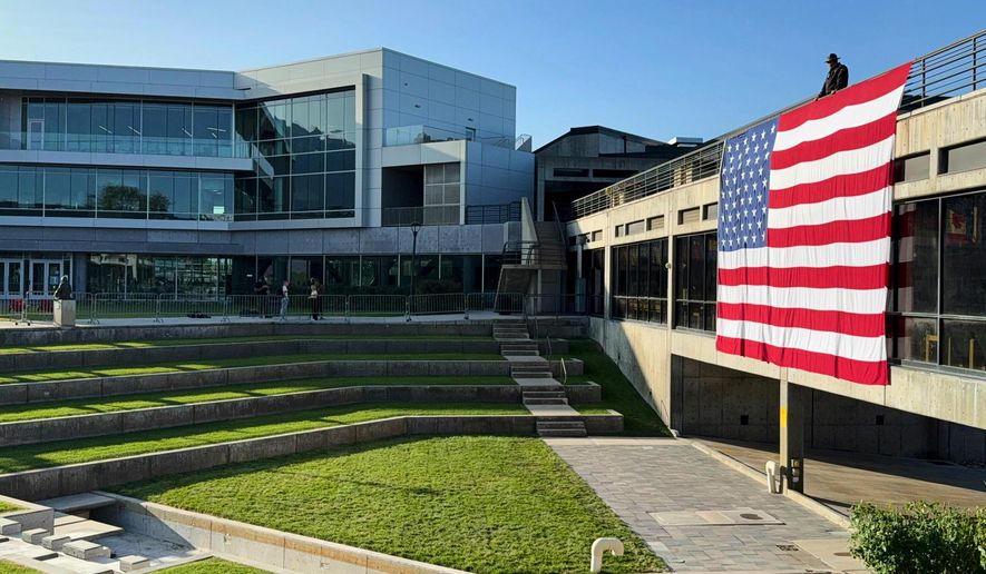 A U.S. flag hangs at Utah Valley University in Orem, Utah, Sept. 17, 2025, over the site where conservative activist Charlie Kirk was shot and killed. (AP Photo/Jesse Bedayn, File)
