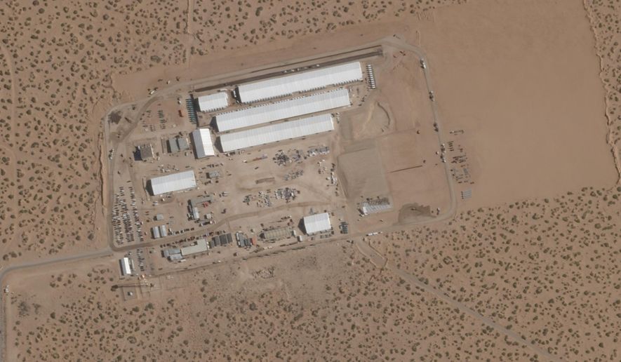 FILE - This Aug. 7, 2025, satellite image shows construction of large white tents for a new immigrant detention center at Fort Bliss, a U.S. Army base outside El Paso, Texas. (Planet Labs via AP, File)