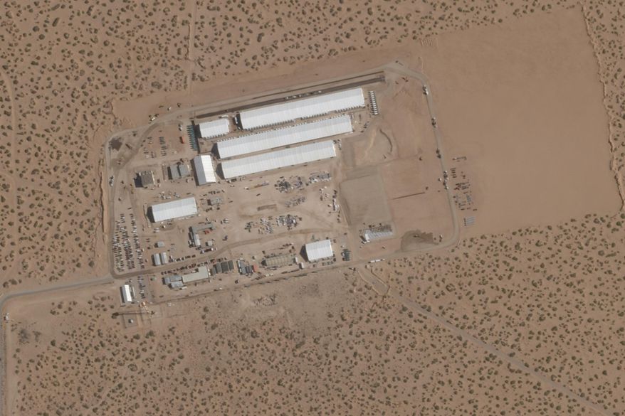 FILE - This Aug. 7, 2025, satellite image shows construction of large white tents for a new immigrant detention center at Fort Bliss, a U.S. Army base outside El Paso, Texas. (Planet Labs via AP, File)