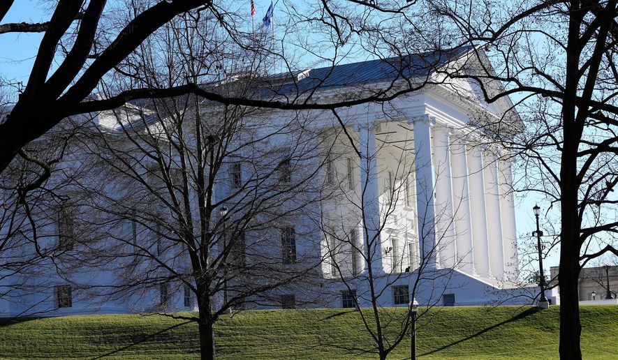 The state and U.S. flags fly over the Virginia State Capitol as the 2024 session of the Virginia General Assembly gets underway, Jan. 10, 2024, in Richmond, Va. (AP Photo/Steve Helber, File)