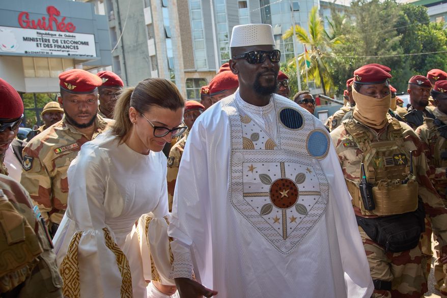 Guinea's President, Gen. Mamadi Doumbouya, arrives with his wife, Lauriane Doumbouya, to cast their votes in the presidential election in Conakry, Guinea, Sunday, Dec. 28, 2025. (AP Photo/Fode Toure)