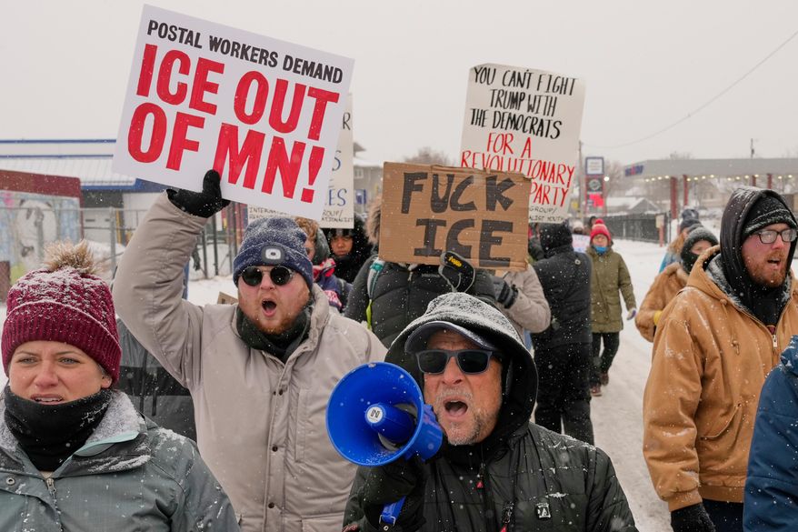 People march and gather near the post office during a protest, Sunday, Jan. 18, 2026, in Minneapolis. (AP Photo/Yuki Iwamura)