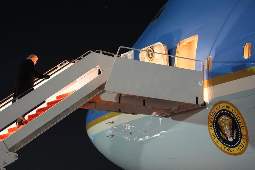 President Donald Trump boards Air Force One for a trip to attend the World Economic Form in Davos, Tuesday, Jan. 20, 2026, at Joint Base Andrews, Md. (AP Photo/Evan Vucci)