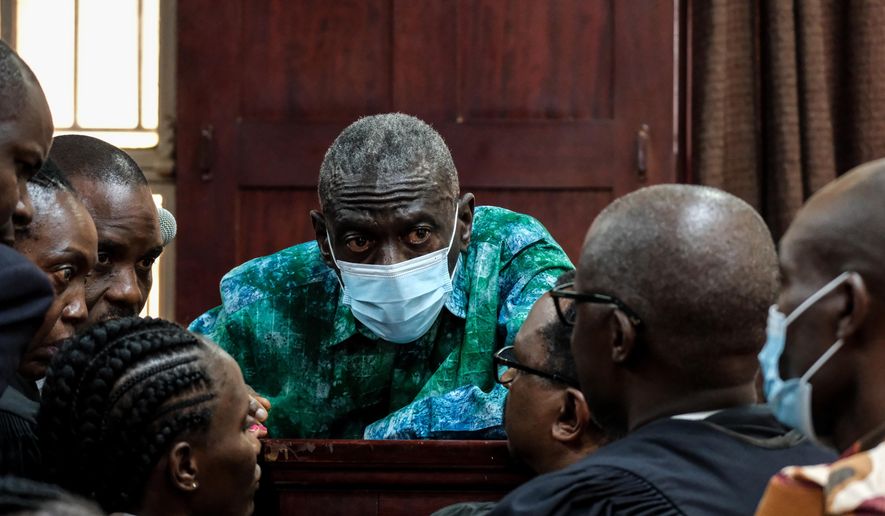 Uganda's veteran opposition leader Kizza Besigye, and his aides seen at High Court, in Kampala, Uganda, Monday, Dec. 29, 2025. (AP Photo/Hajarah Nalwadda)