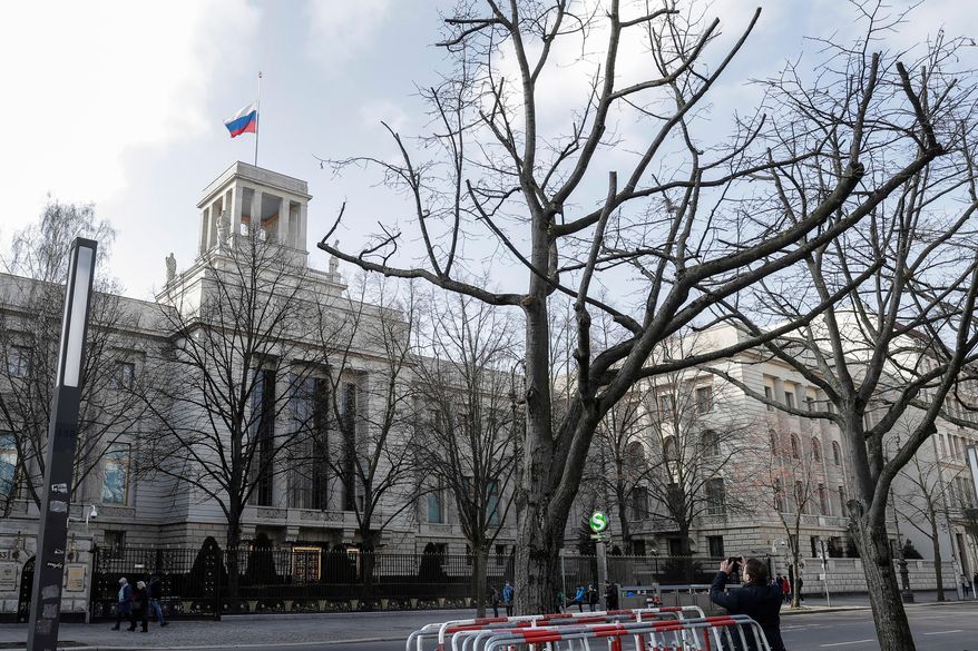 A man takes a photo of the Russian embassy in Berlin, Germany, Tuesday, March 27, 2018. (AP Photo/Markus Schreiber, File)