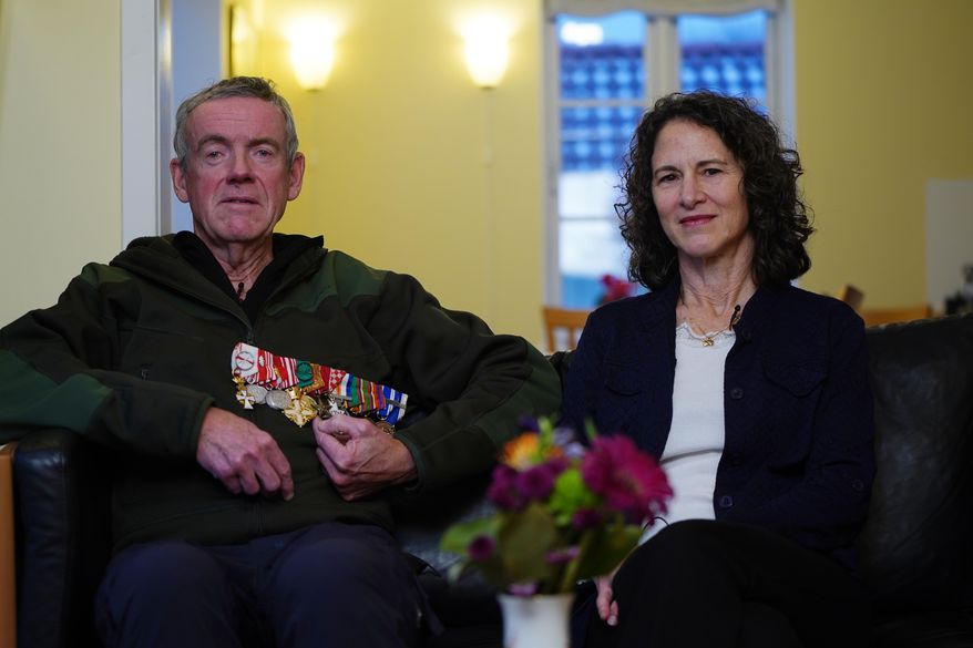 Former Colonel Soren Knudsen and his wife Gina Schaar pose for a photo during an interview with The Associated Press at their home in Copenhagen, Denmark, Tuesday, Jan. 13, 2026. (AP Photo/Anders Garde Kongshaug)