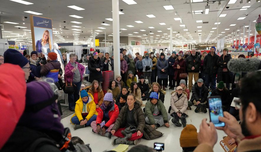 Community members and neighbors of people detained by ICE gather in protest at a Target store, Monday, Jan. 19, 2026, in St. Paul, Minn. (AP Photo/Yuki Iwamura)