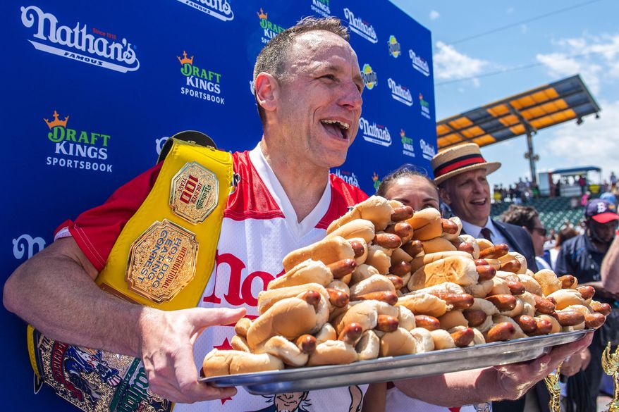 Joey Chestnut, winner of the 2021 Nathan's Famous Fourth of July International Hot Dog-Eating Contest, poses for photos in Coney Island's Maimonides Park, July 4, 2021, in the Brooklyn borough of New York. (AP Photo/Brittainy Newman, File)