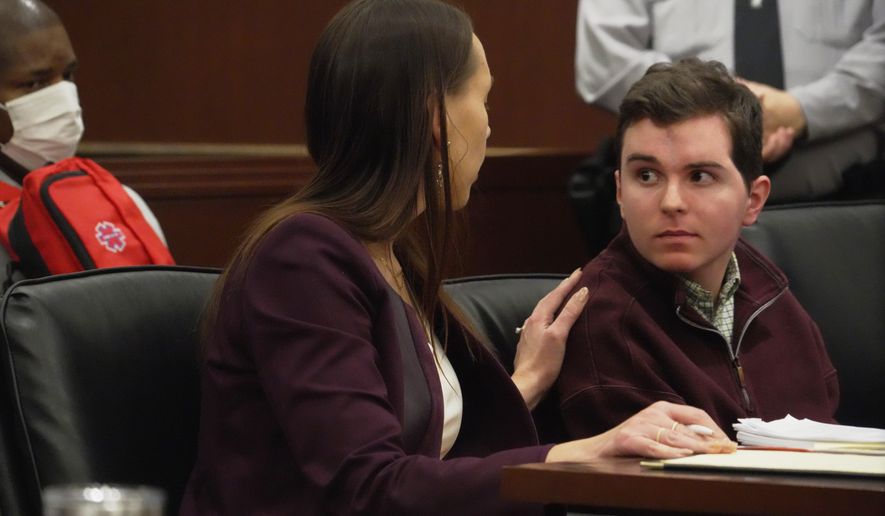 Defense attorney Kellie Mannette touches Austin Thompson's shoulder during a hearing in Wake County Superior Court on Wednesday, Jan. 21, 2026, in Raleigh, N.C. (AP Photo/Allen G. Breed)