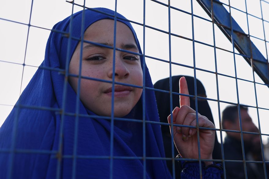 Sundus al-Hassan, 10, poses for a picture inside the al-Hol camp in northeastern Syria's Hasakeh province, Syria, Wednesday, Jan. 21, 2026, after the withdrawal of the Syrian Democratic Forces (SDF). (AP Photo/Ghaith Alsayed)