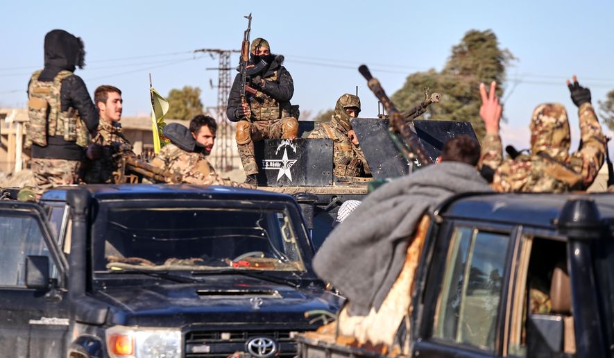 Soldiers of the Kurdish-led, U.S.-backed Syrian Democratic Forces (SDF) deploy with armoured military vehicles to secure roads leading to Gweiran Prison which houses men accused of being an Islamic State (ISIS) fighters in Hassakeh, northeastern Syria, Monday, Jan. 19, 2026. (AP Photo/Baderkhan Ahmad)