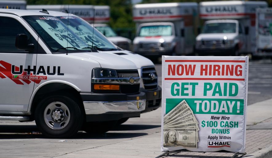 FILE - A sign at a UHaul store looking to hire employees is also offering a bonus, Thursday, May 20, 2021, in Boynton Beach, Fla. (AP Photo/Marta Lavandier, File)