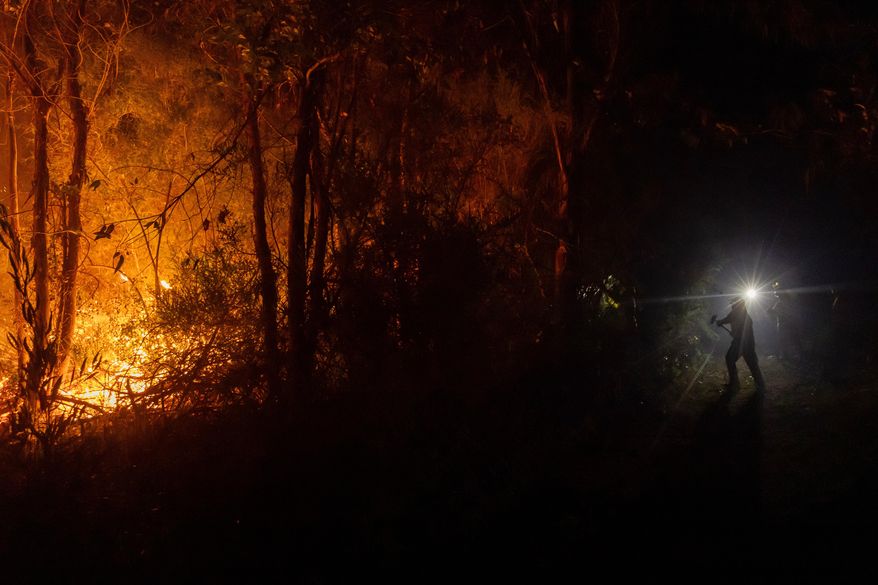 FILE - Firefighters battle a wildfire spreading through a forested area near Concepcion, Chile, Tuesday, Jan. 20, 2026. (AP Photo/Javier Torres, File)