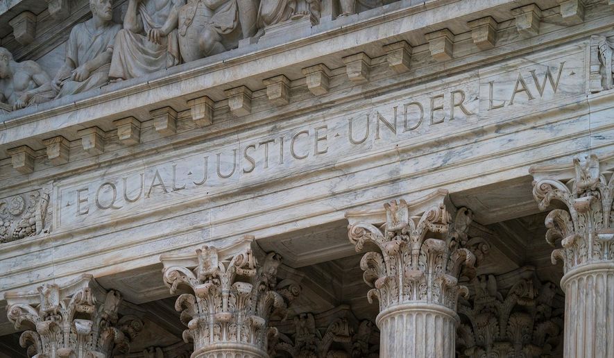 FILE - The west facade of the Supreme Court Building bears the motto "Equal Justice Under Law" on March 20, 2019, in Washington. (AP Photo/J. Scott Applewhite, File)