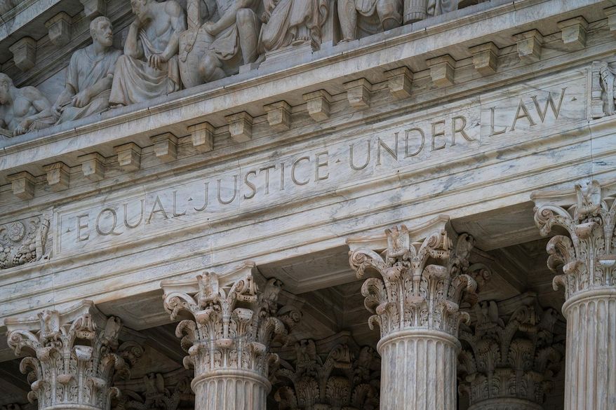 FILE - The west facade of the Supreme Court Building bears the motto "Equal Justice Under Law" on March 20, 2019, in Washington. (AP Photo/J. Scott Applewhite, File)