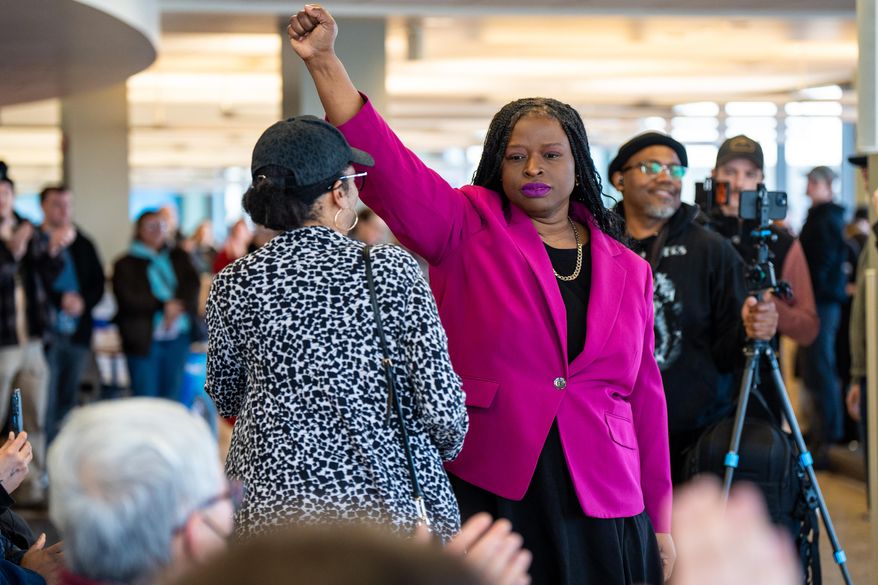 Nekima Levy Armstrong holds up her fist after speaking at an anti-ICE rally for Martin Luther King Jr., Monday, Jan. 19, 2026, in St. Paul, Minn. (AP Photo/Angelina Katsanis)