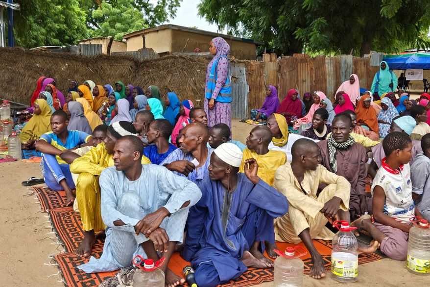 People wait to receive food donations from the United Nations World Food Program in Damasak, northeastern Nigeria, Oct. 6, 2024. (AP Photo/Chinedu Asadu, File)