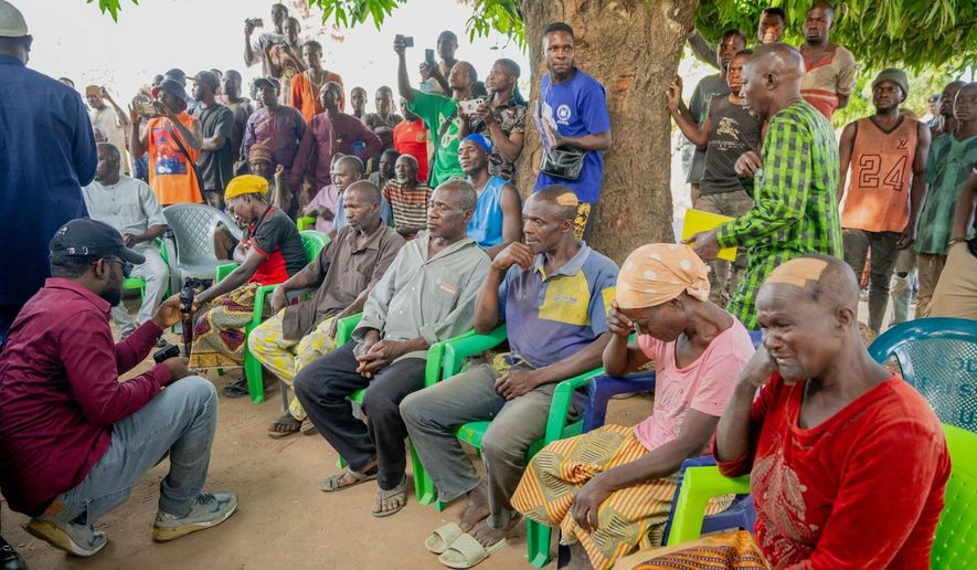 In this photo released by the Kaduna State government, people react during a meeting with Kaduna state Gov. Uba Sani, after gunmen attacked in Kurmin Wali, northwest Nigeria, Wednesday, Jan. 21, 2026. (Kaduna State Government via AP)