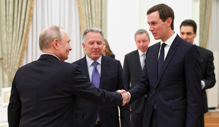 Russian President Vladimir Putin, left, greets U.S. President Donald Trump's envoys, Steve Witkoff, center, and Jared Kushner, at the Senate Palace of the Kremlin, in Moscow, Thursday, Jan. 22, 2026. (Alexander Kazakov/Sputnik, Kremlin Pool Photo via AP)