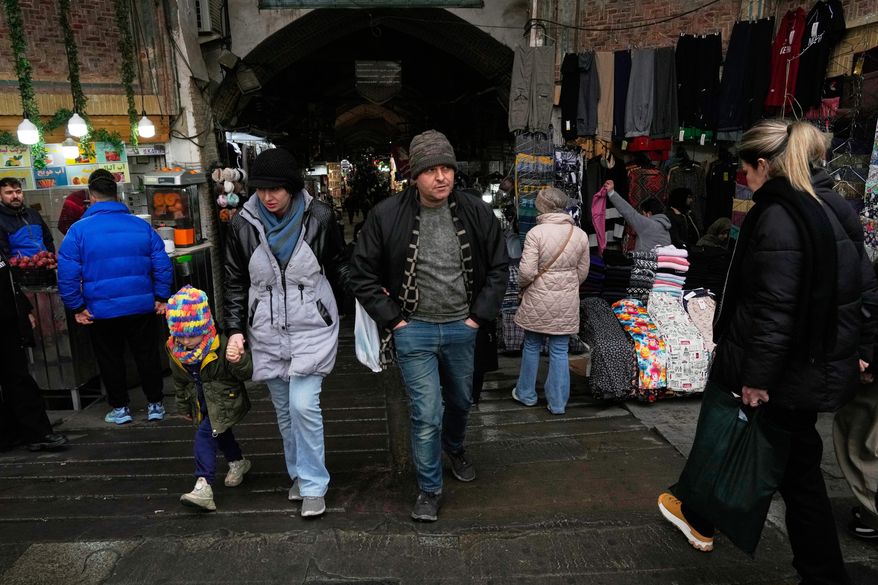 People walk at Tehran's historic Grand Bazaar, Tuesday, Jan. 20, 2026, in Iran. (AP Photo/Vahid Salemi)
