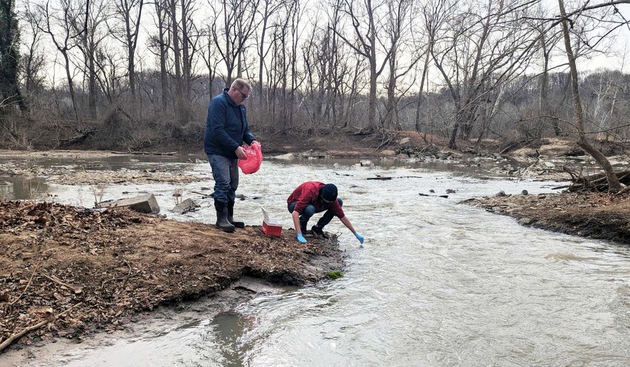 Water samples are taken from the Potomac River, Friday, Jan. 23, 2026 in Glen Echo, Md. A massive pipe that moves millions of gallons of sewage has ruptured and sent wastewater flowing into the Potomac River northwest of Washington, polluting it ahead of a major winter storm that has repair crews scrambling. (AP Photo/Nathan Ellgren)