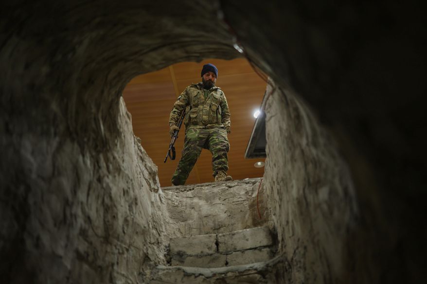 A Syrian security force member stands at the entrance of a tunnel used by retreating Syrian Democratic Forces (SDF) fighters inside the military hospital compound in the town of Ain Issa, northeastern Syria, Saturday, Jan. 24, 2026. (AP Photo/Ghaith Alsayed)