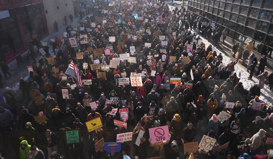 People protest against Immigration and Customs Enforcement in downtown Minneapolis, Sunday, Jan. 25, 2026. (AP Photo/Adam Gray)