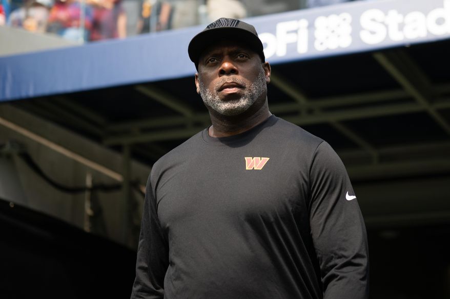 FILE - Washington Commanders running backs coach Anthony Lynn walks on the field before an NFL football game against the Los Angeles Chargers, Oct. 5, 2025, in Inglewood, Calif. (AP Photo/Kyusung Gong, File)