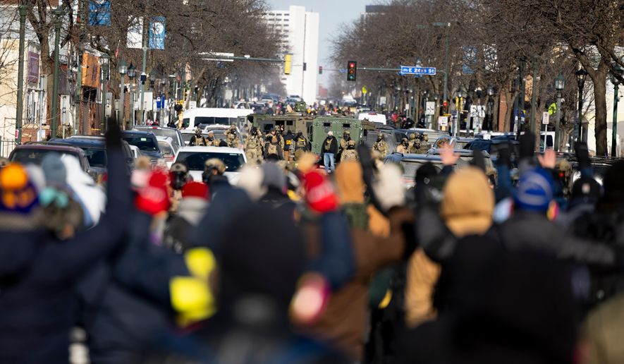 Protesters advance toward federal agents with their hands up near the site of the fatal shooting of 37-year-old Alex Pretti by federal agents in Minneapolis on Saturday, Jan. 24, 2026. (Ellen Schmidt/MinnPost via AP)