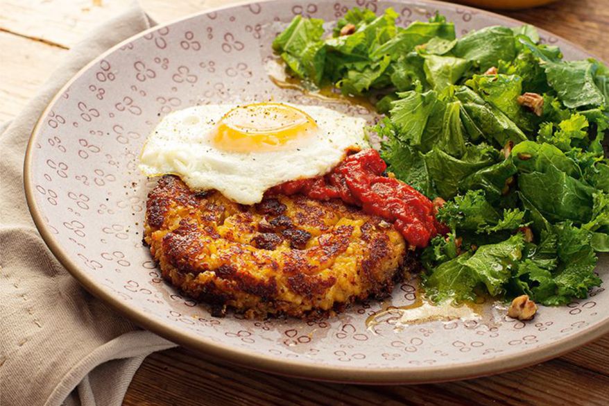 This image released by Voracious shows a recipe for fish cakes with Birmingham greens salad from Marcus Samuelsson's cookbook “The Rise.” (Angie Moser/Voracious via AP)