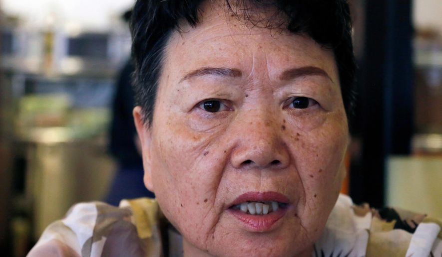 Eiko Kawasaki, a Korean born in Japan, speaks during an interview in Tokyo, Friday, Aug. 24, 2018. (AP Photo/Yuri Kageyama, File)