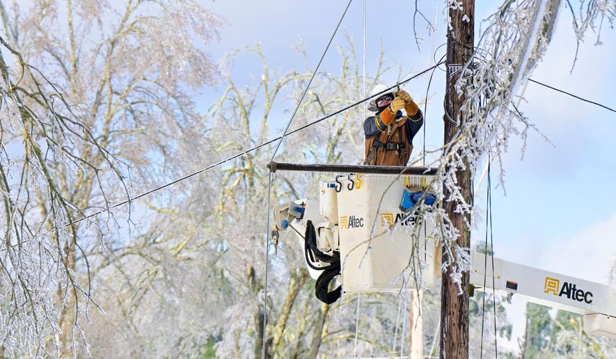 A lineman works to restore power in Oxford, Miss. on Monday, Jan. 26, 2026, following a weekend ice storm. (AP Photo/Bruce Newman)