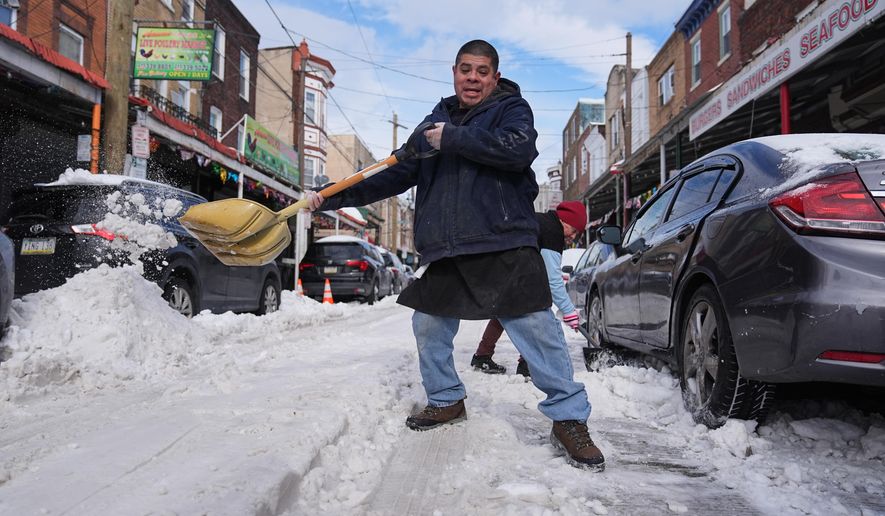 Gilberto Hernandez shovels snow in the aftermath of a winter storm in Philadelphia, Monday, Jan. 26, 2026. (AP Photo/Matt Rourke)