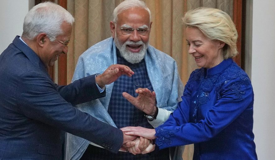 Indian Prime Minister Narendra Modi, center, welcomes European Council President Antonio Costa, left and European Commission President Ursula von der Leyen before their meeting in New Delhi, India, Tuesday, Jan. 27, 2026. (AP Photo/Manish Swarup)