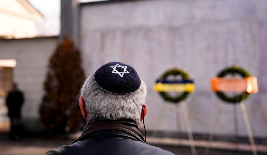 A Jewish man attends a ceremony commemorating the extermination of the Jewish people and their deportation to Nazi concentration camps on Holocaust Remembrance Day, at the Monumental Cemetery, in Turin, Italy, Tuesday, Jan. 27, 2026. (Fabio Ferrari/LaPresse via AP)