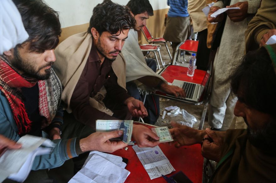 Government workers get information from people, who fled from Tirah, a town in the Khyber Pakhtunkhwa province, amid uncertainty over a military operation against the Pakistani Taliban, at a registration center in Bara, a town of Pakistan's northwestern Khyber district, Tuesday, Jan. 27, 2026. (AP Photo/Muhammad Sajjad)