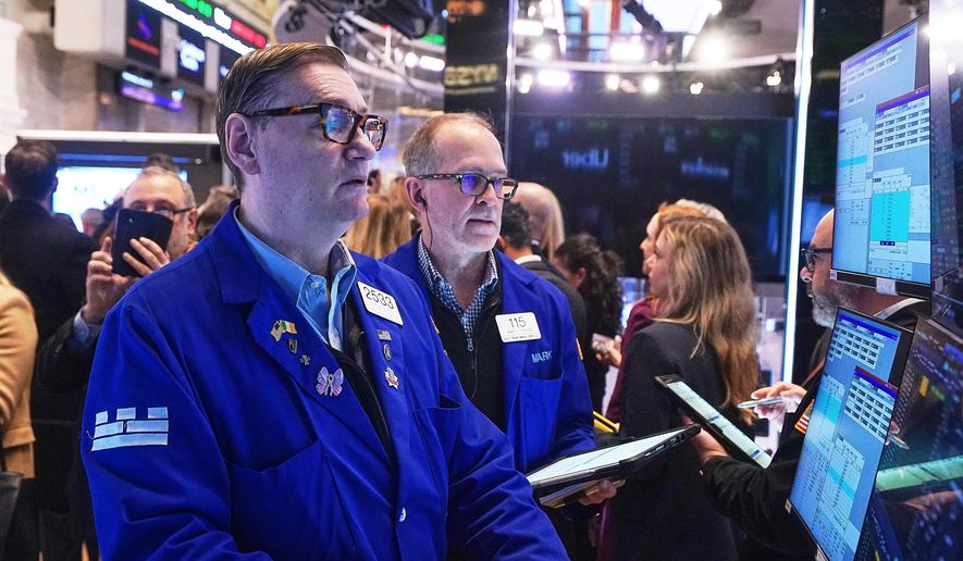 Specialist Patrick King, left, and trader Mark Puetzer work on the floor of the New York Stock Exchange, Wednesday, Jan. 28, 2026. (AP Photo/Richard Drew)