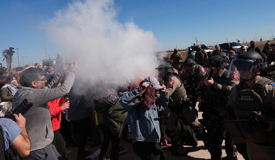 Pepper spray is dispersed towards protesters outside the South Texas Family Residential Center detention facility where Liam Ramos and his father are being detained in Dilley, Texas, Wednesday, Jan. 28, 2026. (AP Photo/Eric Gay)