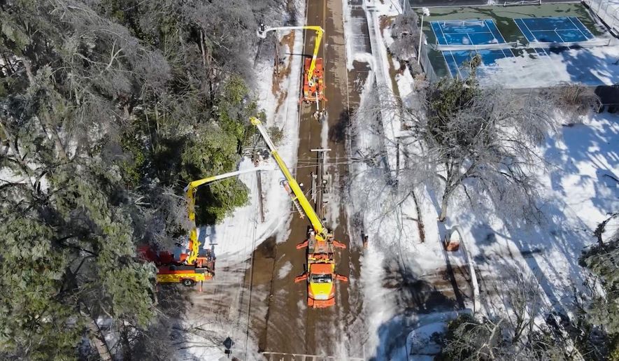 This image taken from a video released by the city of Oxford, Miss., shows crews working on power lines Tuesday, Jan. 27, 2026. (City of Oxford Mississippi via AP)