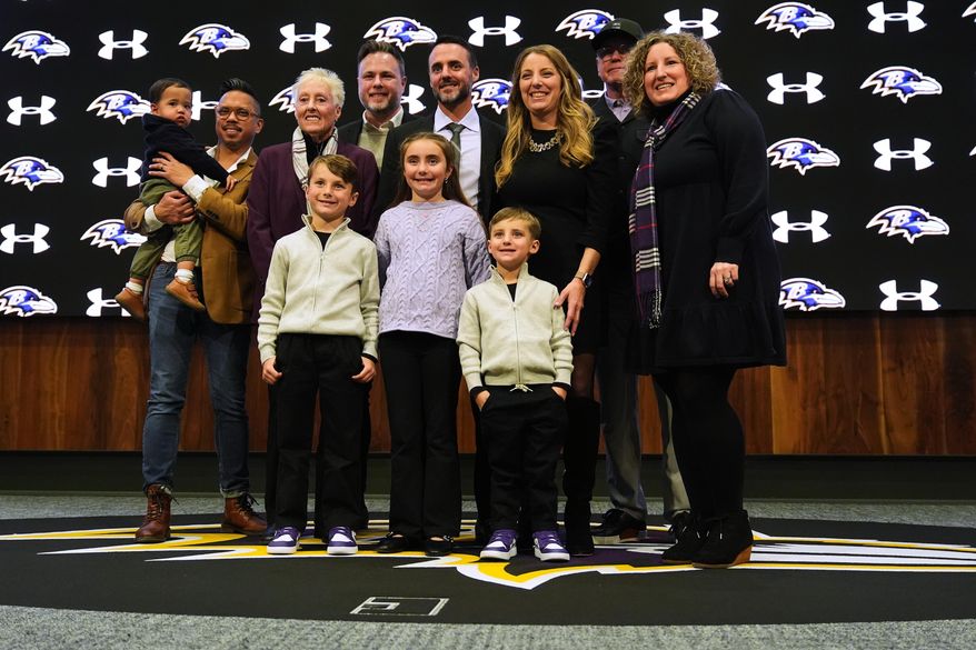 Baltimore Ravens head coach Jesse Minter poses for a photo with his family after an introductory press conference at the Under Armour Performance Center in Owings Mills, Md., Thursday, Jan. 29, 2026. (AP Photo/Stephanie Scarbrough)